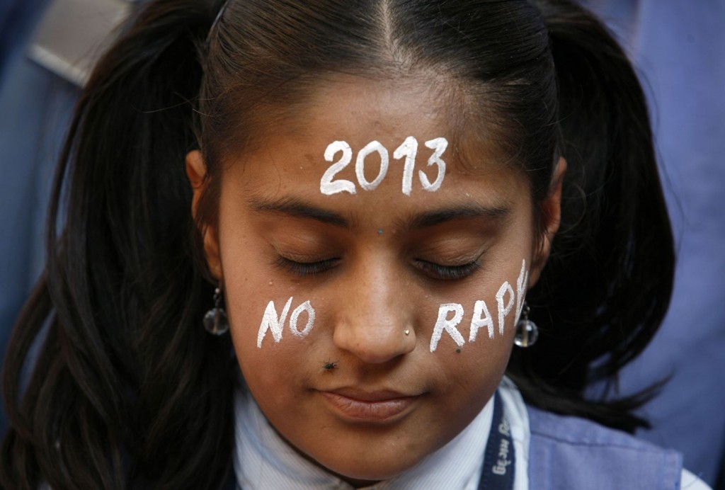 一名印度女孩，在黑公交輪姦案受害者悼念會中，在臉上寫上 2013 零強姦的祝願。攝影：AMIT DAVE / REUTERS
